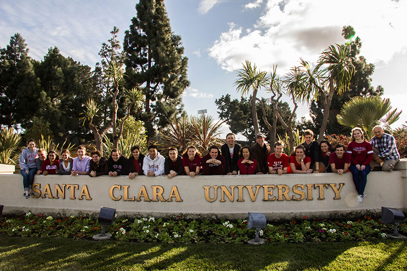 Students gathered at the Santa Clara University entrance sign