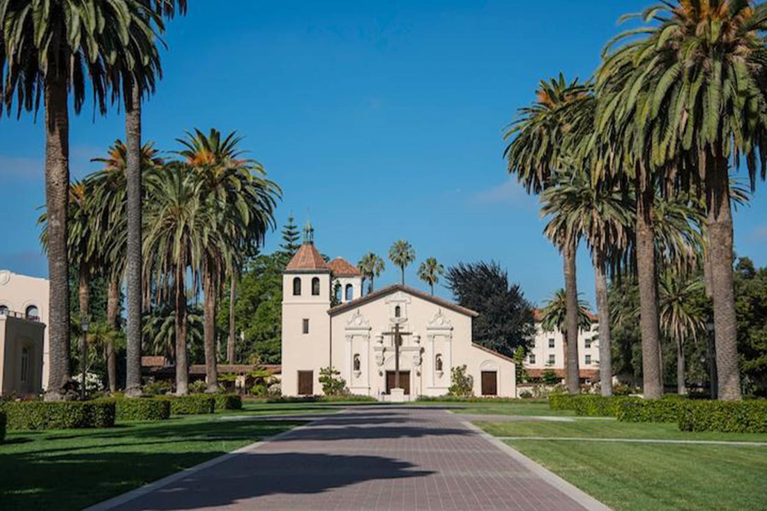 Mission Santa Clara de As&iacute;s church approached by a palm-lined path